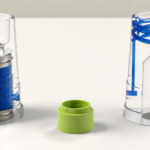 Two clear cylindrical housings with blue internal components and a lime-green cap between them: left a blue filter sponge inside a metal-top cartridge; right a tall chamber with blue coiled tubing and a diamond-shaped insert inside.
